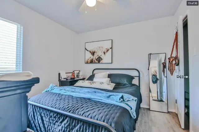 a bedroom with a bed and a window