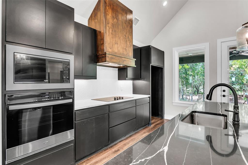 391 Slate Rock Road Ennis, TX 75119 - Photo 13 of 40 Off kitchen looking towards garage door and half bathroom