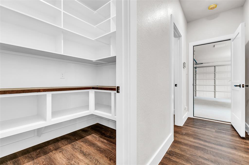 391 Slate Rock Road Ennis, TX 75119 - Photo 14 of 40 Off kitchen looking towards garage door and half bathroom