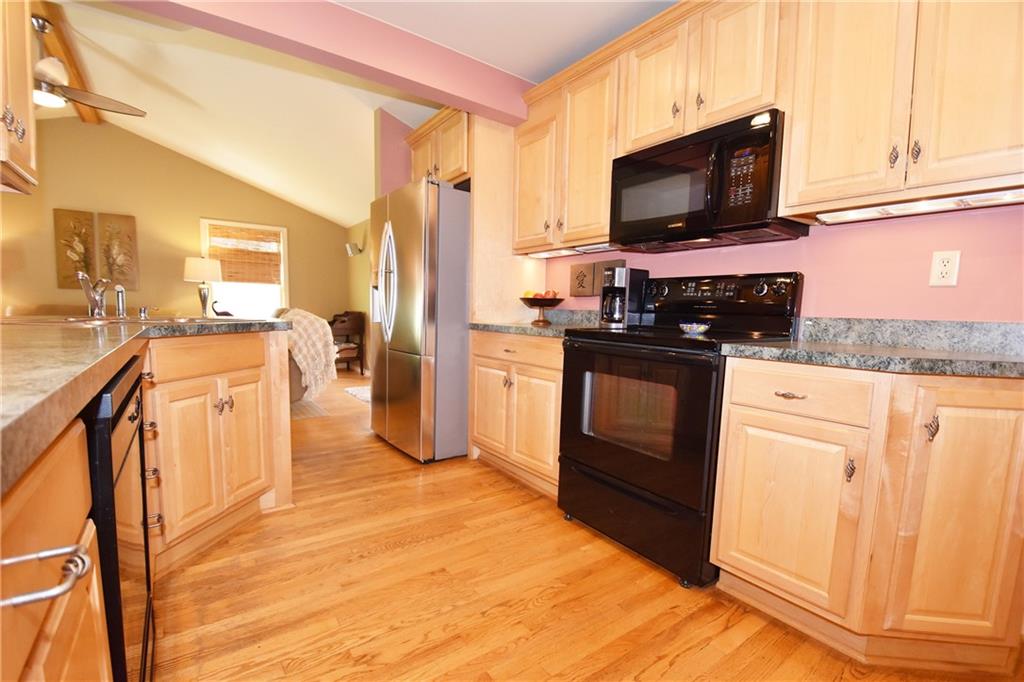 294 Old Farm Road Pittsburgh, PA 15228 - Photo 9 of 25 a kitchen with stainless steel appliances granite countertop a stove a sink and a refrigerator