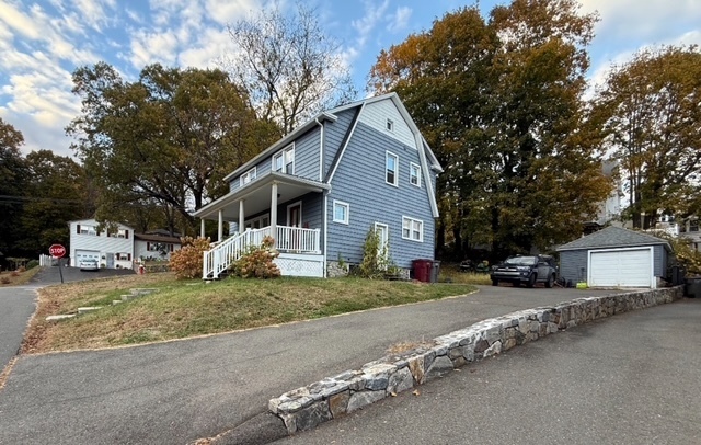 43 Marshall Avenue Naugatuck, CT 06770 - Photo 2 of 11 a front view of a house with a yard and garage