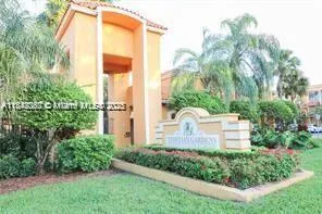 a front view of a house with a yard and plants