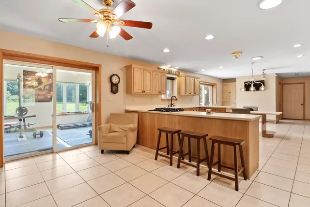 a living room with furniture and kitchen view