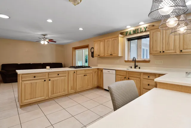 a kitchen with a sink cabinets and window