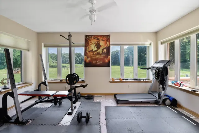 a living room with furniture floor to ceiling window and floor to ceiling window