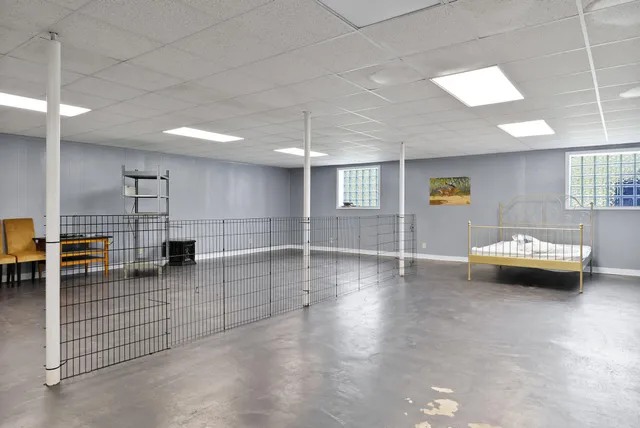 a view of a big house with a big yard and large trees