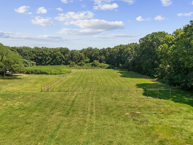 a view of yard with swimming pool and green space