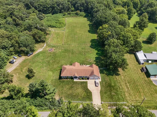 an aerial view of a house with a yard
