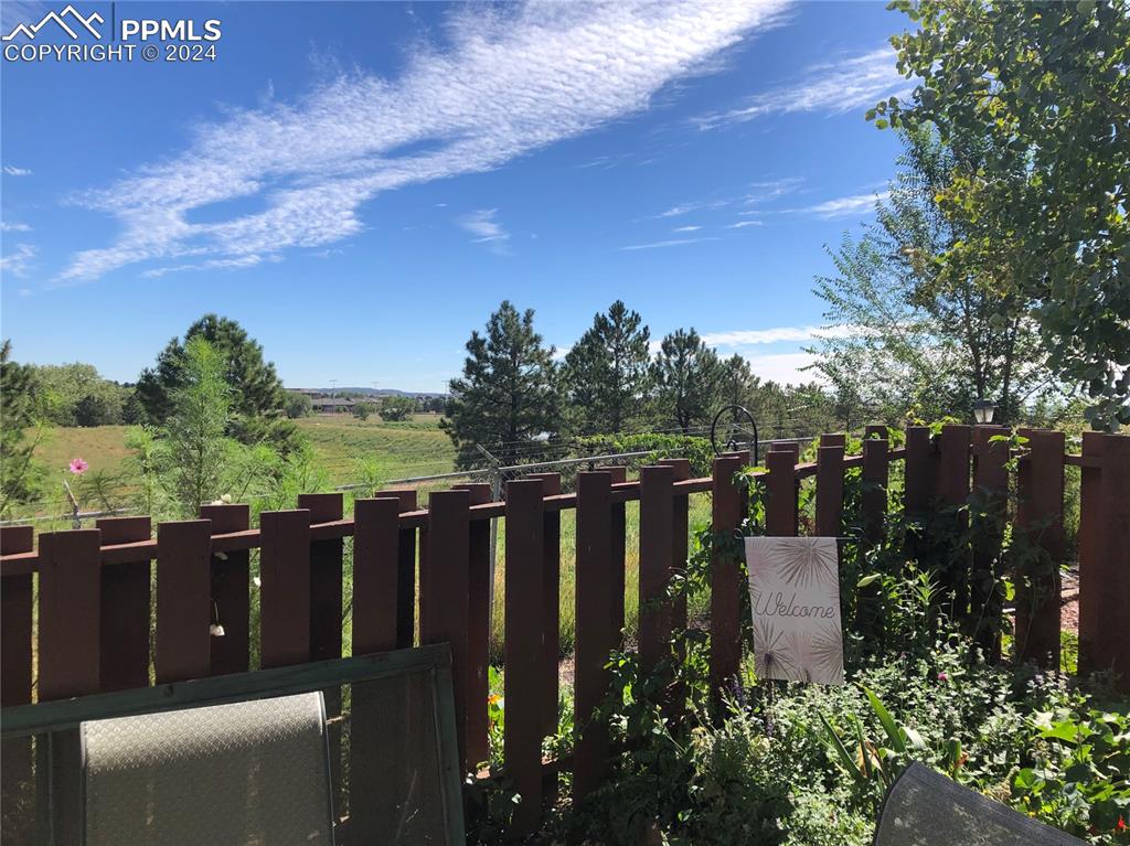 2953 Mesa Road, Unit B Colorado Springs, CO 80904 - Photo 11 of 17 a view of a deck with mountain view and garden