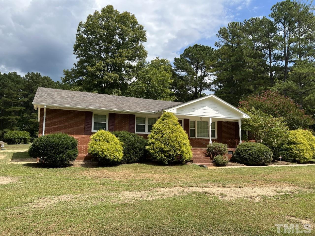 821 Snow Hill Road Durham, NC 27712 - Photo 2 of 15 a front view of a house with a yard and garage