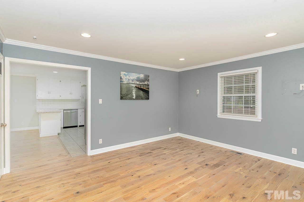 821 Snow Hill Road Durham, NC 27712 - Photo 4 of 15 a view of empty room with wooden floor and windows