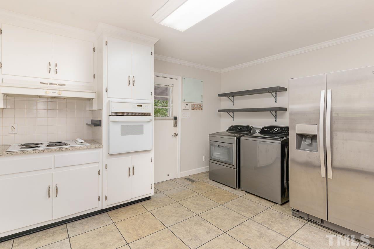 821 Snow Hill Road Durham, NC 27712 - Photo 8 of 15 a kitchen with granite countertop white cabinets and stainless steel appliances