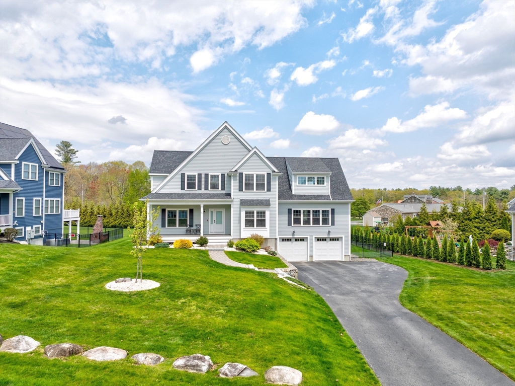 51 Tamarack Road Dracut, MA 01826 - Photo 3 of 39 a front view of a house with garden and trees