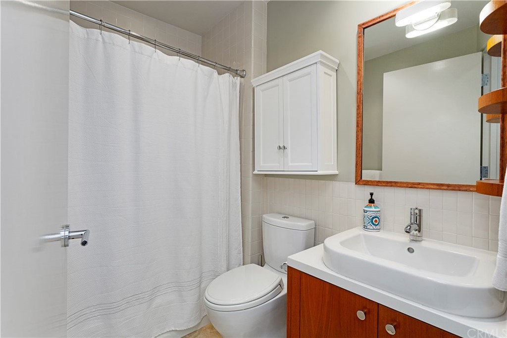 50 Monarch Bay Drive Dana Point, CA 92629 - Photo 25 of 34 a bathroom with a sink a toilet and a mirror