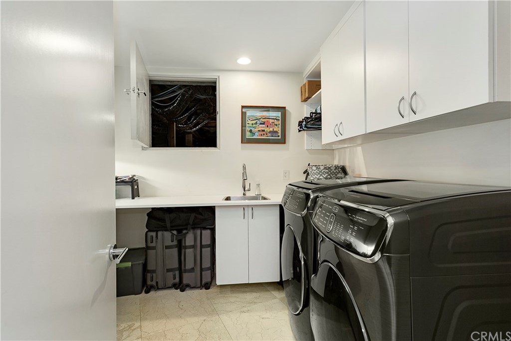 50 Monarch Bay Drive Dana Point, CA 92629 - Photo 27 of 34 a utility room with sink dryer and washer