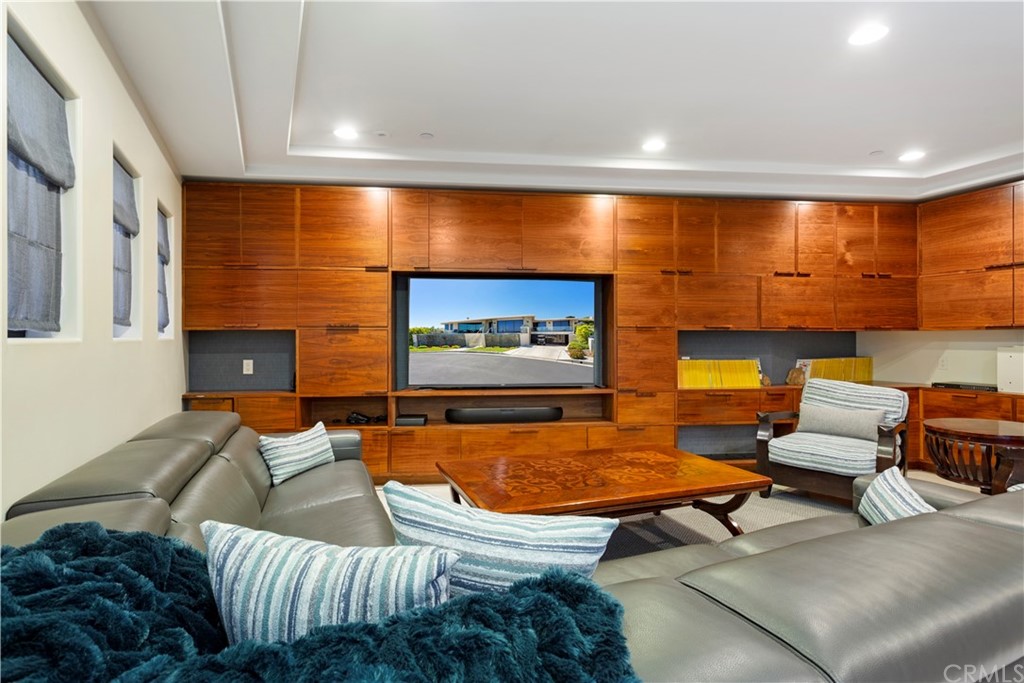 50 Monarch Bay Drive Dana Point, CA 92629 - Photo 28 of 34 a living room with furniture and a projector screen