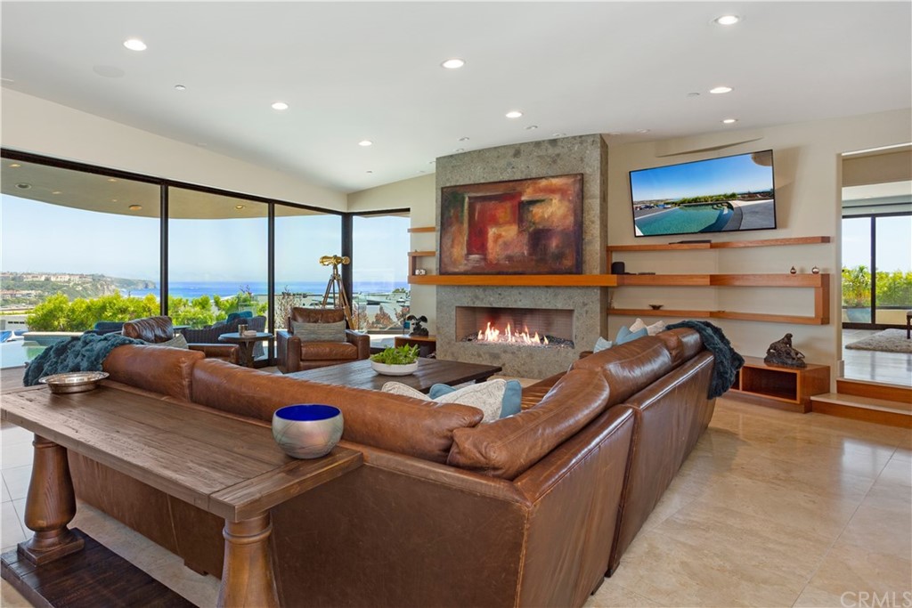 50 Monarch Bay Drive Dana Point, CA 92629 - Photo 8 of 34 a living room with furniture a flat screen tv and a floor to ceiling window