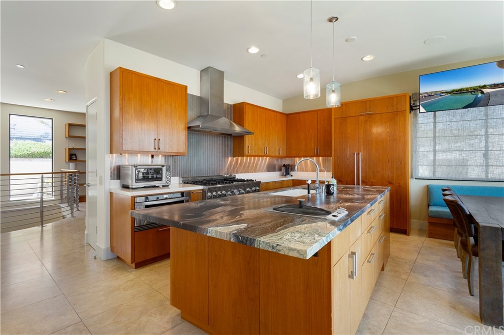 50 Monarch Bay Drive Dana Point, CA 92629 - Photo 9 of 34 a kitchen with stainless steel appliances granite countertop a sink a stove and a refrigerator