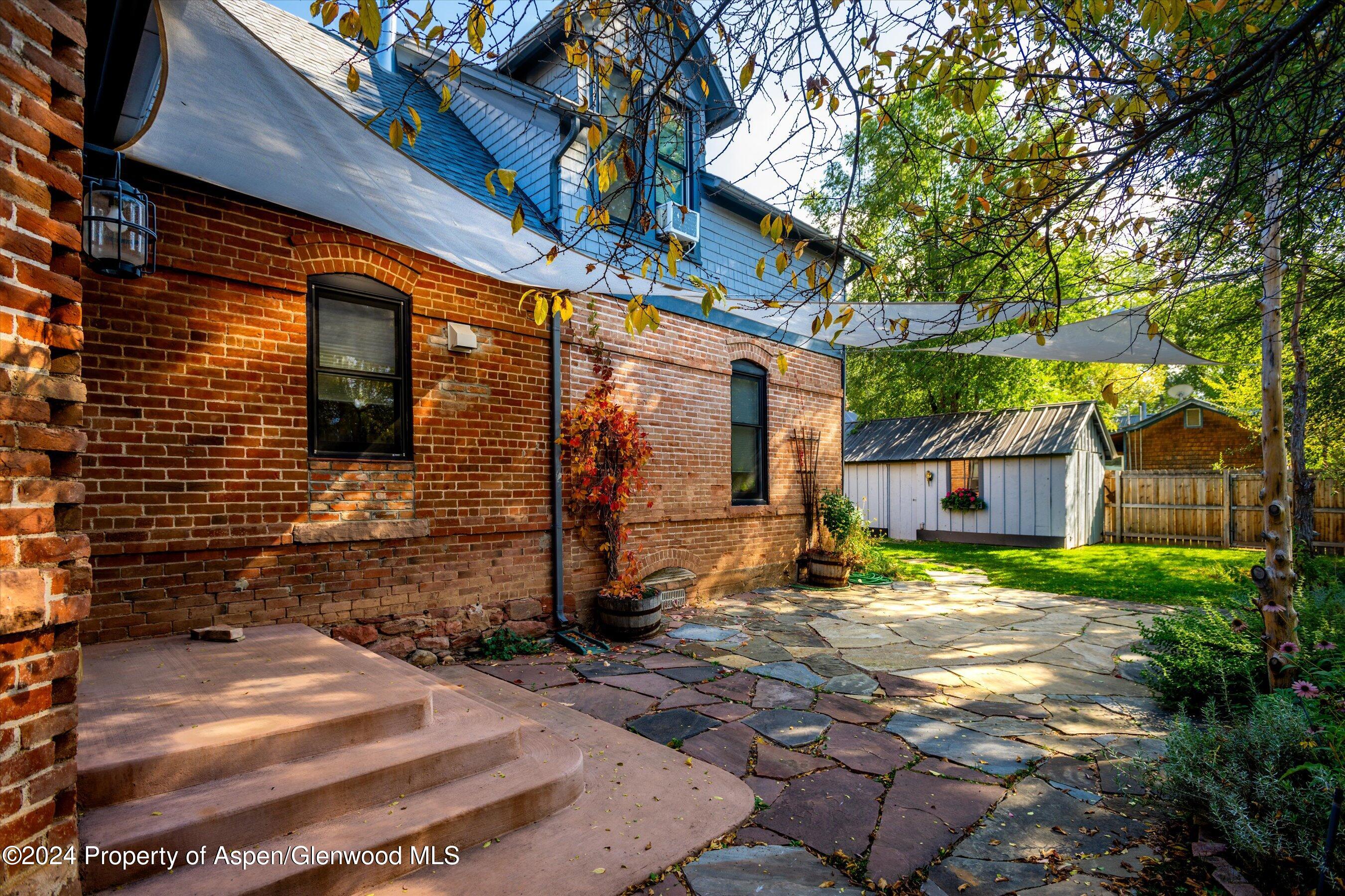156 Garfield Avenue Carbondale, CO 81623 - Photo 19 of 24 a backyard of a house with plants and large tree