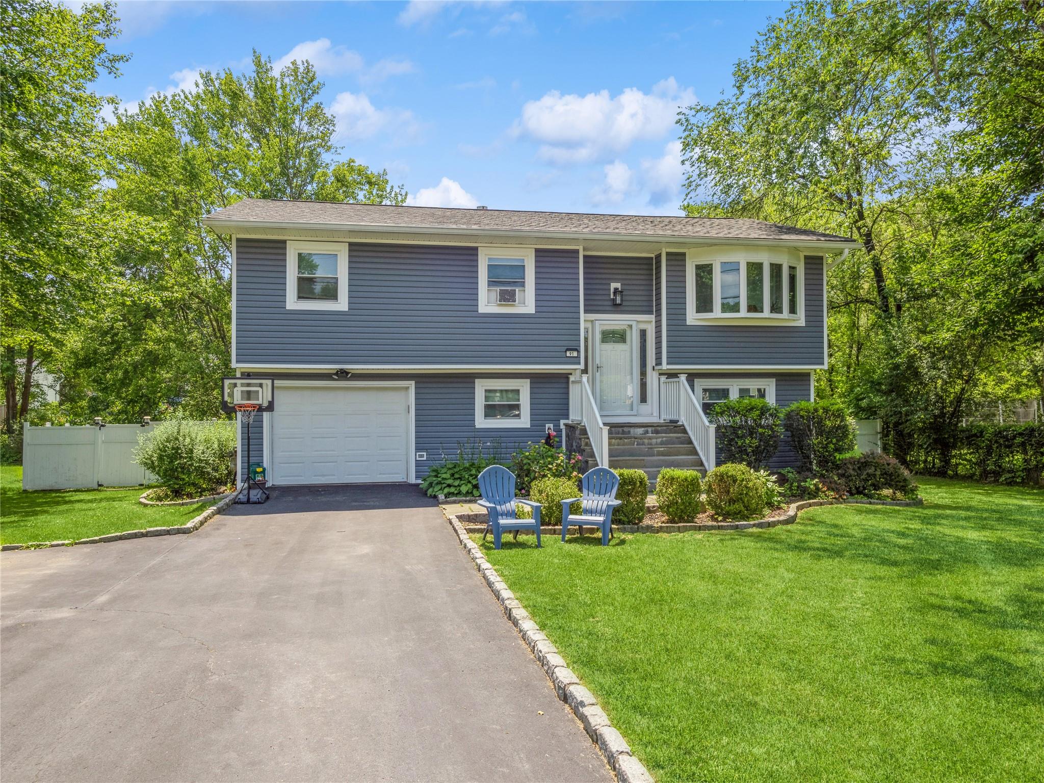 a front view of house with yard and green space