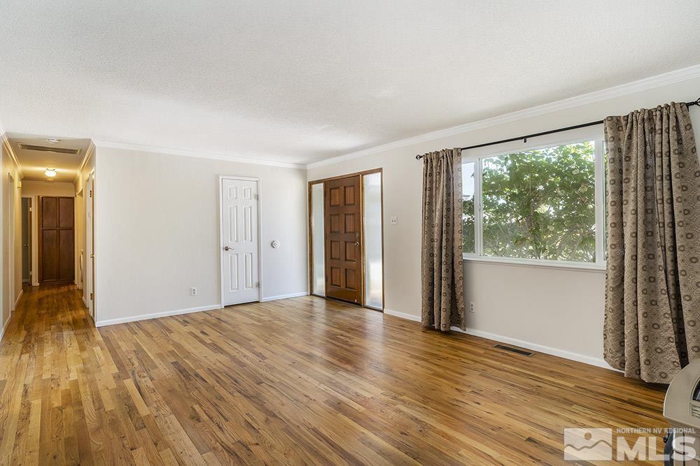 1531 Rayburn Drive Reno, NV 89503 - Photo 12 of 26 a view of an empty room with wooden floor and a window