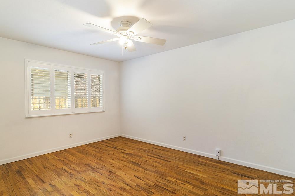 1531 Rayburn Drive Reno, NV 89503 - Photo 14 of 26 a view of an empty room with wooden floor and a window
