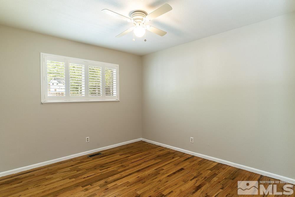 1531 Rayburn Drive Reno, NV 89503 - Photo 18 of 26 a view of an empty room with wooden floor and a window