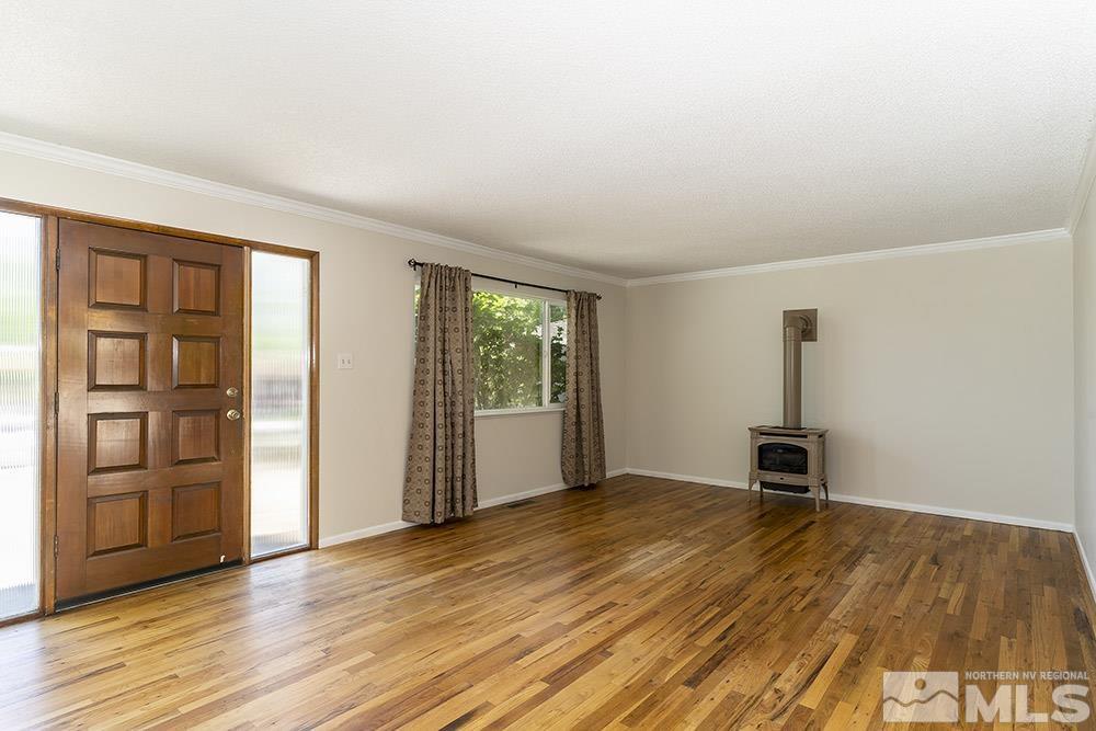 1531 Rayburn Drive Reno, NV 89503 - Photo 3 of 26 an empty room with wooden floor closet and windows