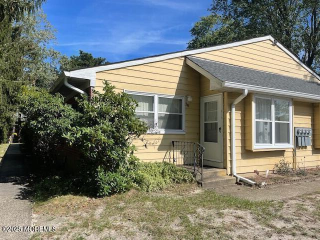 a view of house with backyard and garden
