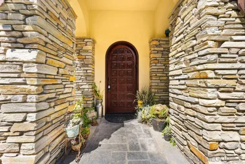 a front view of a house with a garden