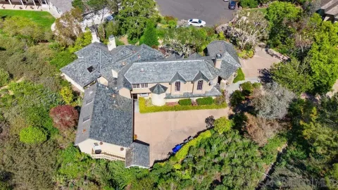 an aerial view of a house with a swimming pool
