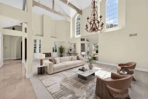 a living room with furniture and painting on the wall