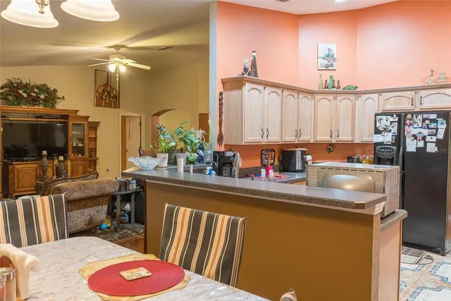a view of kitchen island with stainless steel appliances granite countertop sink stove and cabinets