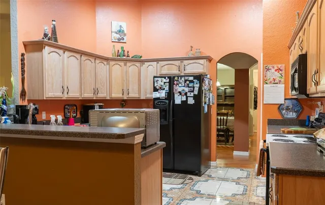 a kitchen with stainless steel appliances granite countertop a refrigerator and a stove