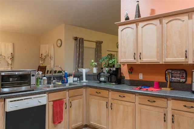 a kitchen with stainless steel appliances granite countertop a sink and cabinets