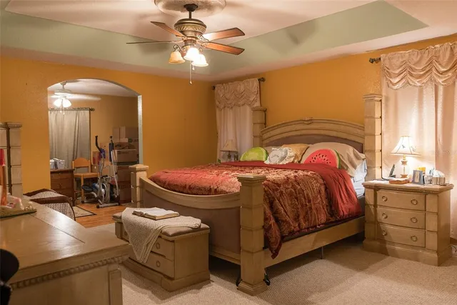 a bedroom with a bed and a painting on the wall