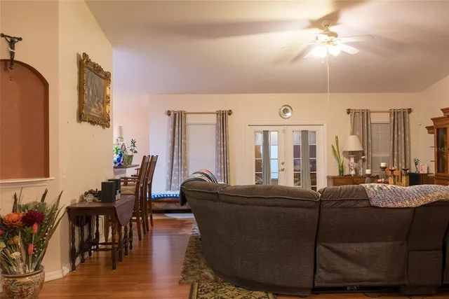 a living room with furniture and wooden floor
