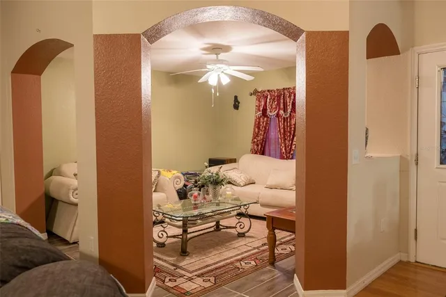 a living room with furniture and a chandelier