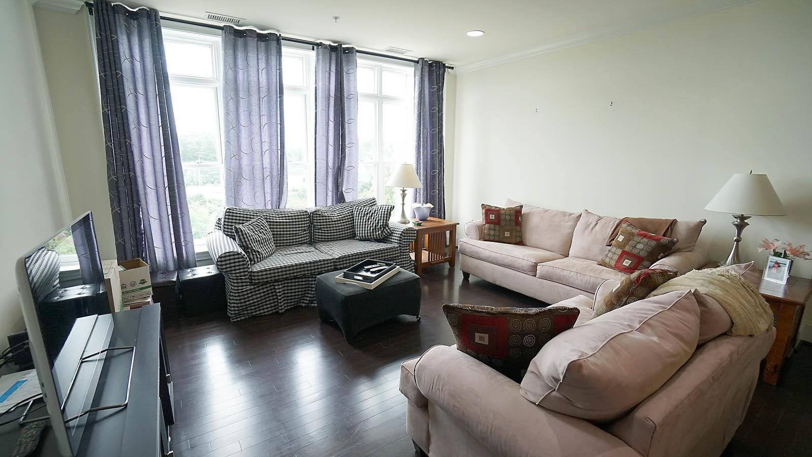 710 Independence Place, Unit 309 Raleigh, NC 27603 - Photo 6 of 32 Beautiful living room with floor to ceiling windows and hardwood flooring. Living Room