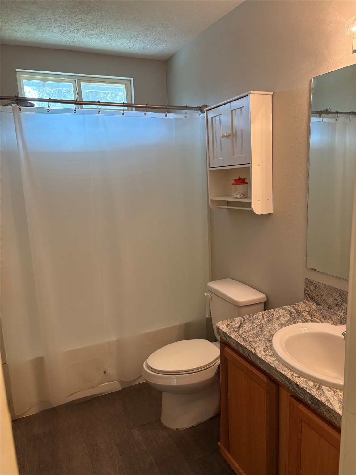 3940 Frontier Road Willis, TX 77378 - Photo 7 of 13 a bathroom with a granite countertop sink a toilet and mirror