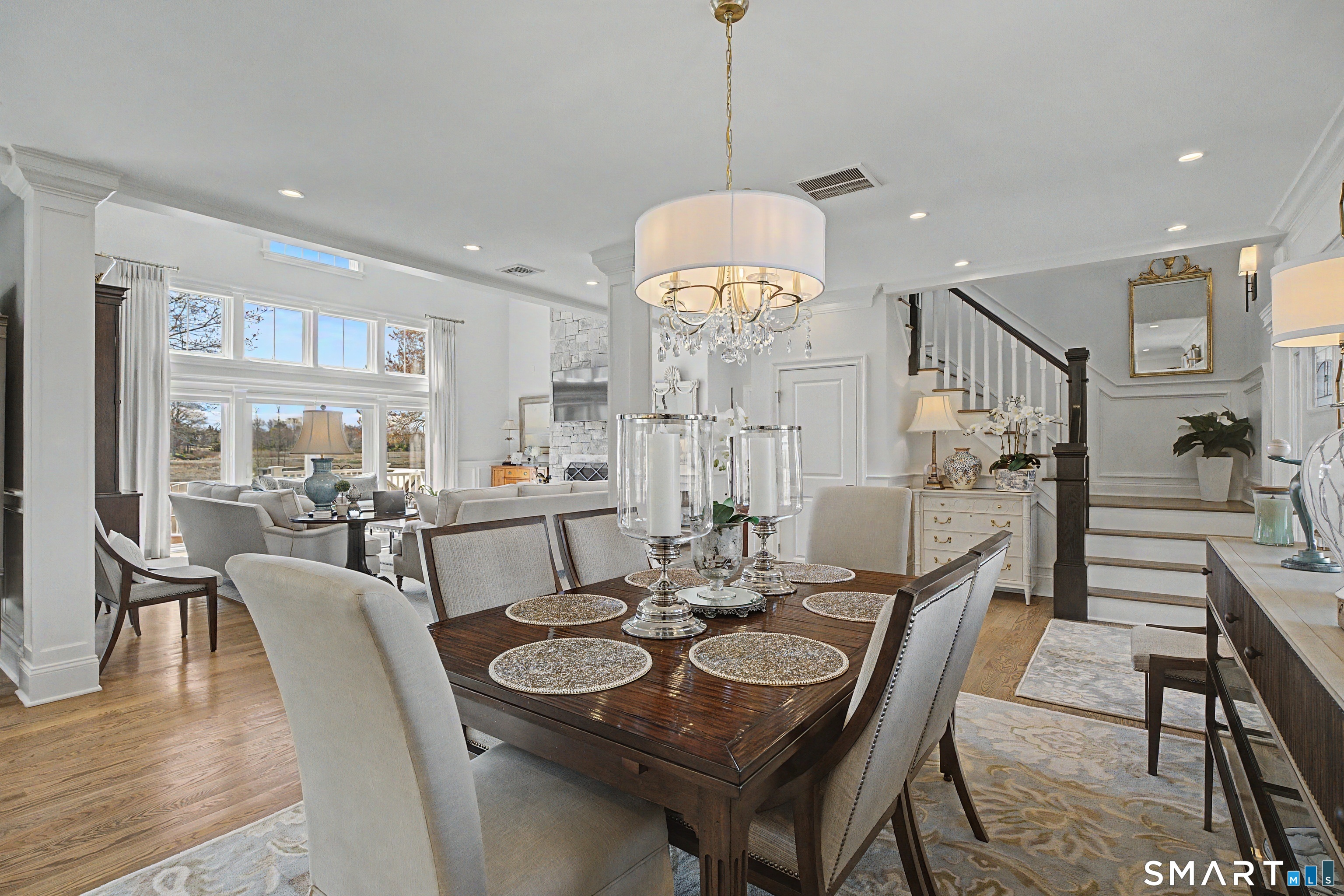 101 Garnet Park Road Madison, CT 06443 - Photo 12 of 40 a view of a dining room and livingroom furniture a chandelier and wooden floor