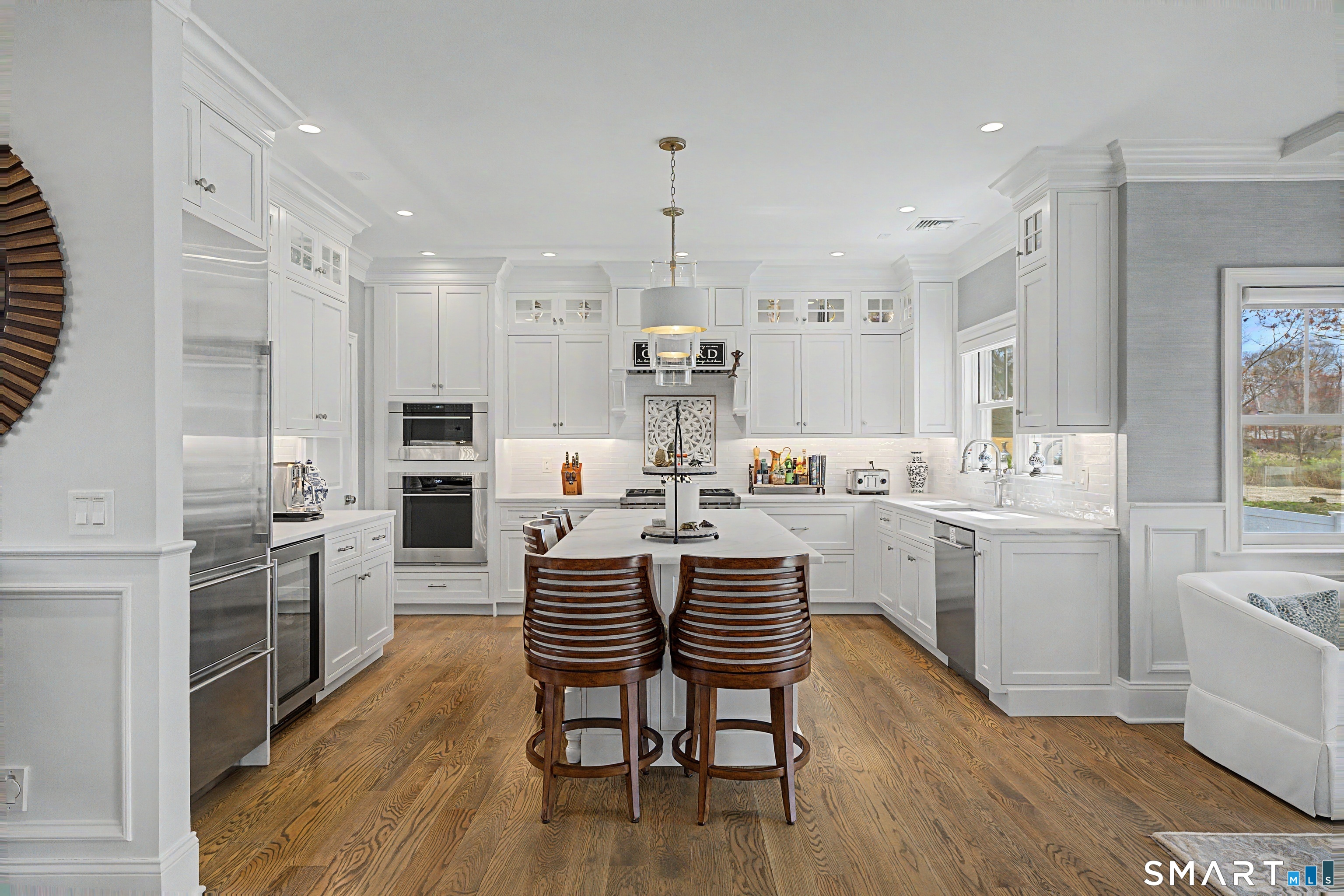 101 Garnet Park Road Madison, CT 06443 - Photo 8 of 40 a kitchen with a dining table chairs appliances and cabinets