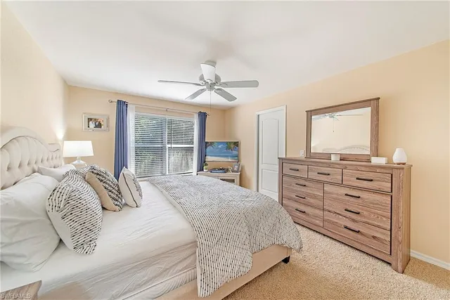 a bedroom with a large bed and a large window