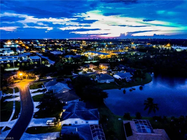 an aerial view of residential houses with outdoor space and street view