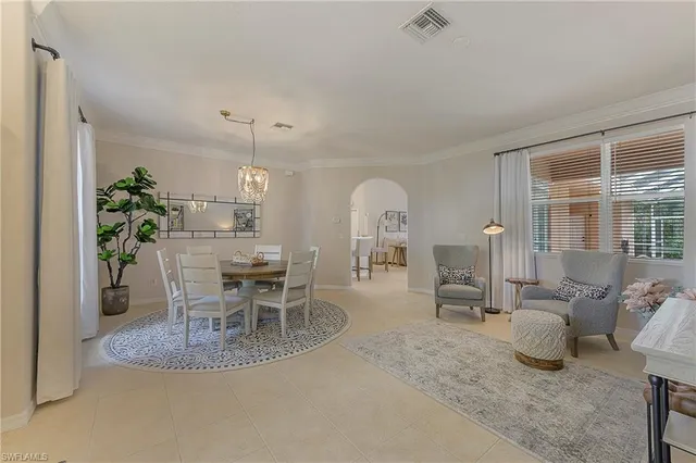 a dining room with furniture and a chandelier