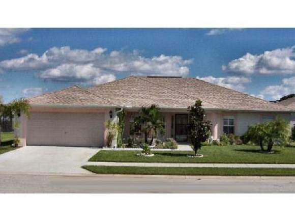 7746 Fringe Port Cocoa, FL 32927 - Photo 1 of 1 a front view of a house with a yard