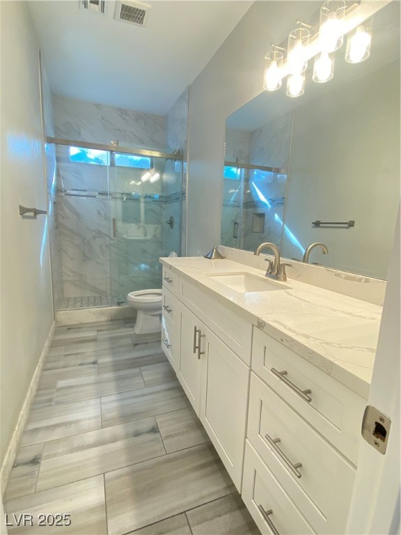 9637 Greensburg Avenue Las Vegas, NV 89178 - Photo 12 of 33 Bathroom featuring a marble finish shower, visible vents, toilet, vanity, and baseboards