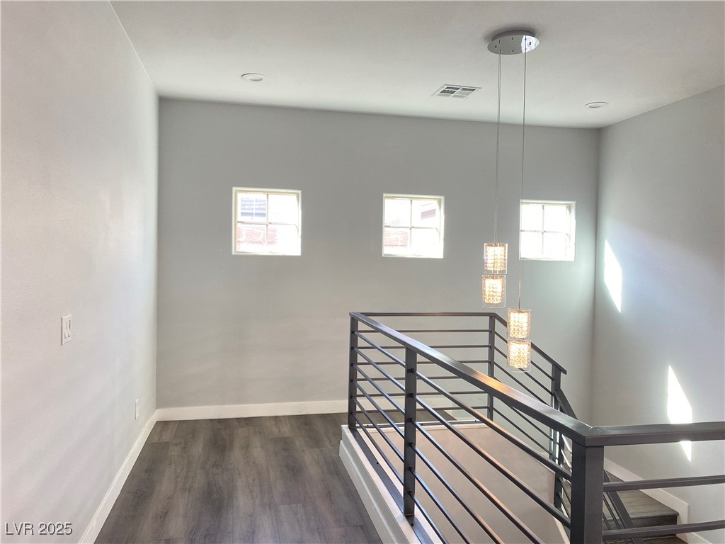 9637 Greensburg Avenue Las Vegas, NV 89178 - Photo 16 of 33 Stairway with visible vents, baseboards, and wood finished floors