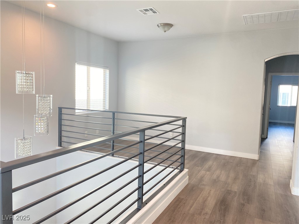9637 Greensburg Avenue Las Vegas, NV 89178 - Photo 17 of 33 Hall with a healthy amount of sunlight, visible vents, arched walkways, and an upstairs landing