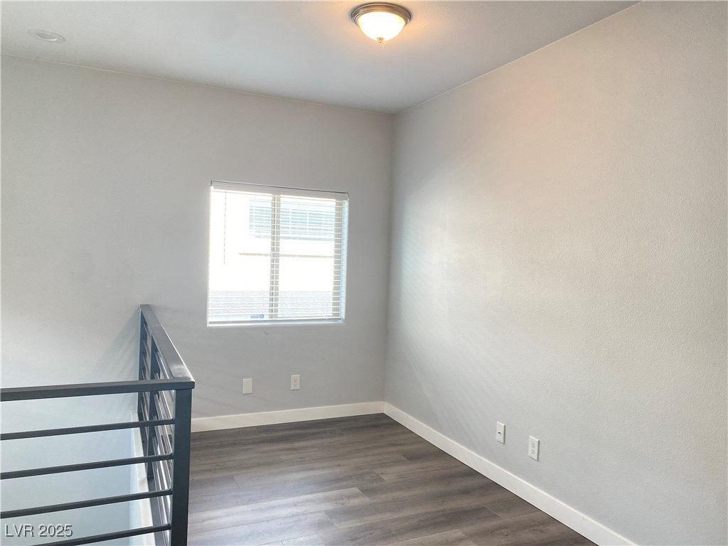 9637 Greensburg Avenue Las Vegas, NV 89178 - Photo 18 of 33 Spare room featuring dark wood finished floors and baseboards